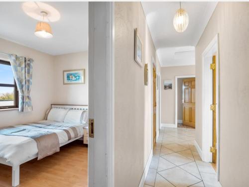 a bedroom with a bed and a hallway at Inishnee Haven in Galway