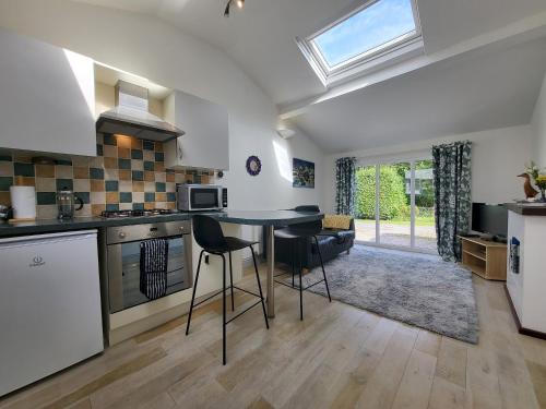a kitchen and living room with a table and chairs at Juniper HAYLOFT Grasmere in Ambleside