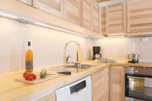 a kitchen with a sink and a bottle of wine at Cabin Huskyfarm Innset in Innset