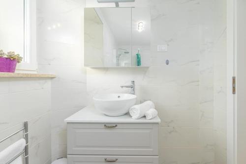 a white bathroom with a sink and a mirror at Villa Dobrila by IstriaLux in Stari Pazin