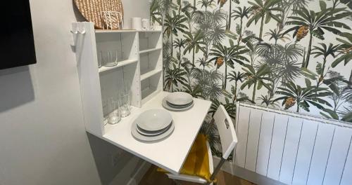 a white table with plates on it in a kitchen at Market Dream King Bed, Deluxe Town Centre Studio in Northampton