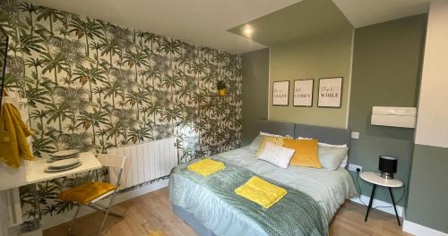 a bedroom with a bed with a tropical wallpaper at Market Dream King Bed, Deluxe Town Centre Studio in Northampton