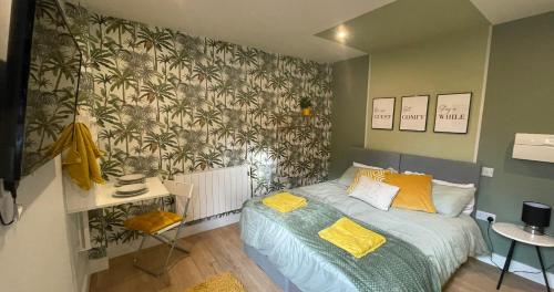 a bedroom with a bed with a green wall at Market Dream King Bed, Deluxe Town Centre Studio in Northampton