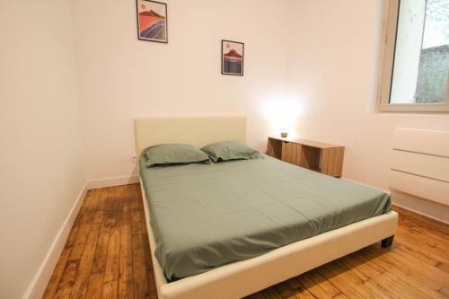 une chambre avec un lit dans une pièce blanche dans l'établissement New ! La casa 3 - rénové - Wifi - vue dégagée, à Angoulême
