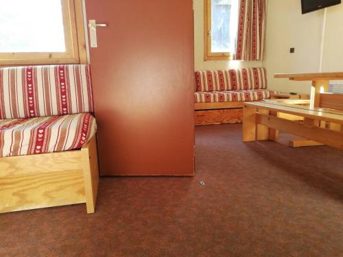 une chambre avec un banc et une table. dans l'établissement Studio 3 pers, pieds des pistes et ESF, proche commerces - FR-1-356-345, à Valmorel