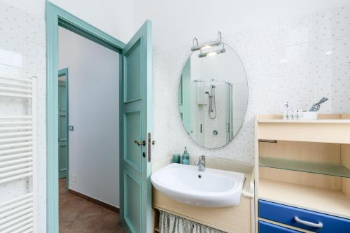 a bathroom with a sink and a mirror at 'Casa di Vivi' 300m from the beach Free Wifi Netflix in Moneglia