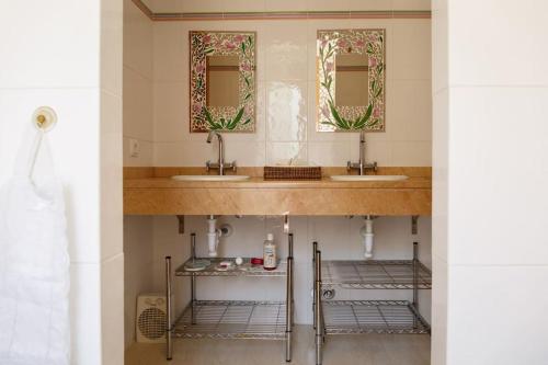 a bathroom with two sinks and two mirrors at BEACH VILLA with PRIVATE POOL in Palma de Mallorca
