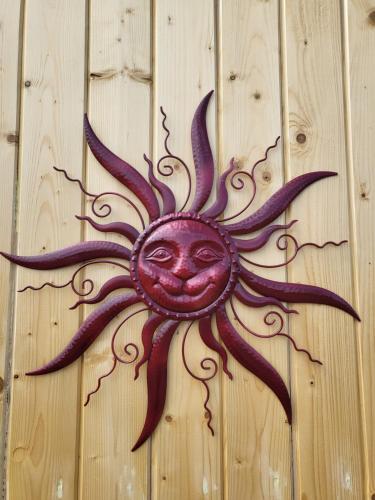 a sun cut out on a wooden wall at Casa en Sol -Therme Balotesti in Baloteşti
