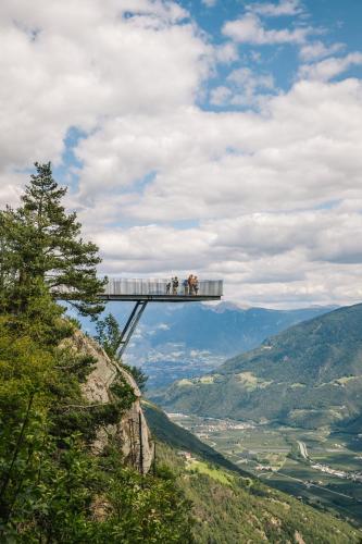 a group of people standing on a bridge on a mountain at apartments arduus - high living in Naturno