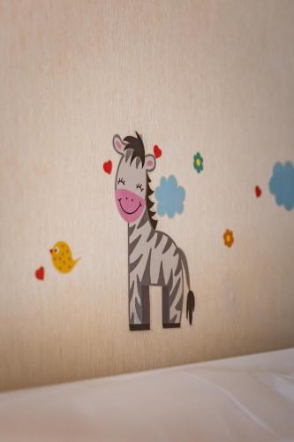 a zebra wall decal on a bedroom wall at The Red Lion Hotel in Hillingdon