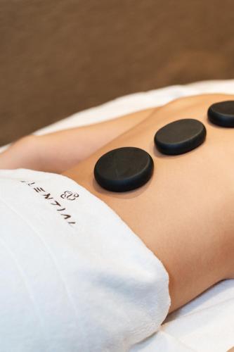a close up of a womans back with black buttons at Renaissance Santiago by Marriott in Santiago