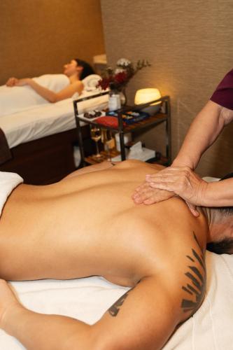 a man getting a back massage in a hotel room at Renaissance Santiago by Marriott in Santiago