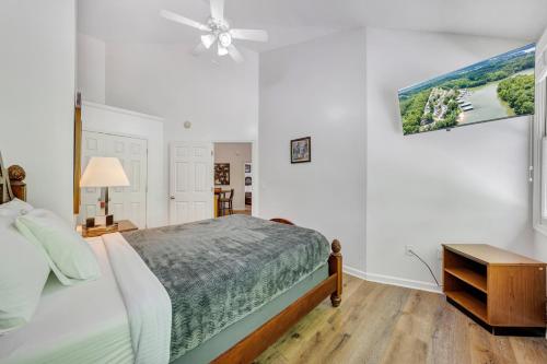 a bedroom with a bed and a ceiling fan at Halesford Harbour Resort - Smith Mountain Lake in Moneta