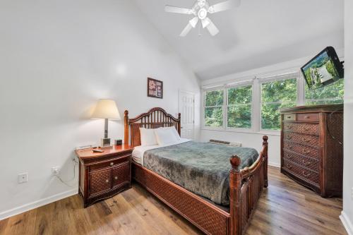 a bedroom with a bed and a dresser and a window at Halesford Harbour Resort - Smith Mountain Lake in Moneta