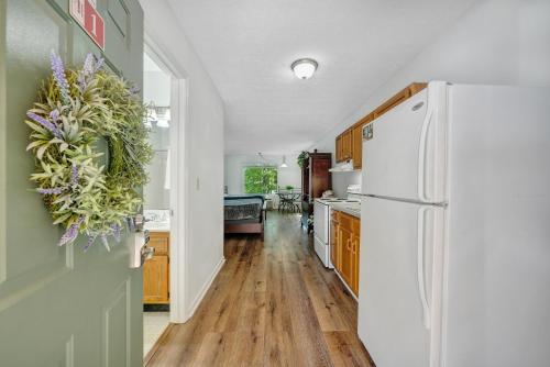a kitchen with a white refrigerator and wooden floors at Halesford Harbour Resort - Smith Mountain Lake in Moneta