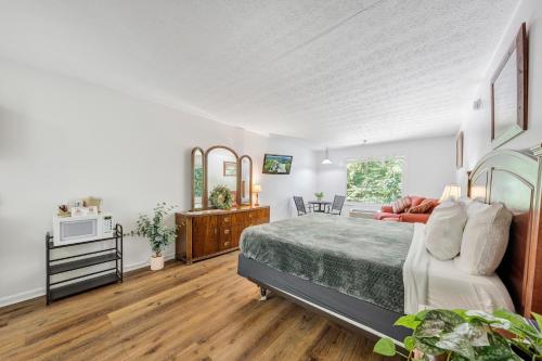 a large bedroom with a bed and a couch at Halesford Harbour Resort - Smith Mountain Lake in Moneta