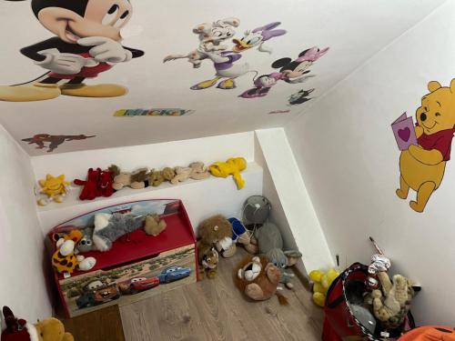 a bedroom with mickey mouse stickers on the ceiling at Casa Dudu in Moieciu de Jos