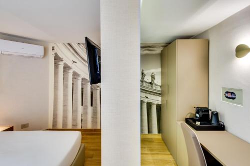 a room with a bed and a view of a building at Relais Badoer in Rome