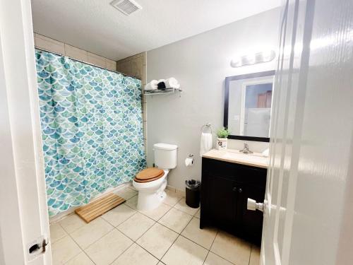 a bathroom with a toilet and a sink and a shower at Unobstructed Oceanfront SAND DOLLAR Unit 7 Beach Pad! in Surfside Beach
