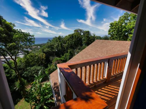 a balcony with a view of the ocean at Incredible Ocean Views From Both Sides Of This Hill Top Home, in West Bay