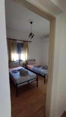 a room with two beds and a mirror at Grey house in Samos