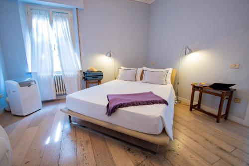 a bedroom with a large white bed and a window at Belle Viste - Boutique Apartments in Bettolle