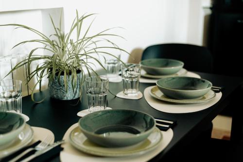 a black table with plates and bowls and glasses at La Portesina Mantova in Mantova