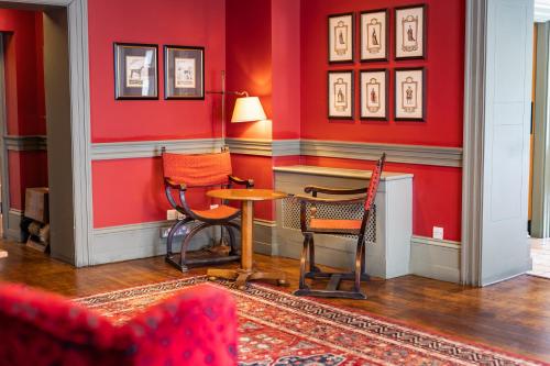 a red room with two chairs and a table at The Red Lion Hotel in Hillingdon