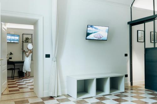 a woman standing in a hallway next to a table at La Portesina Mantova in Mantova