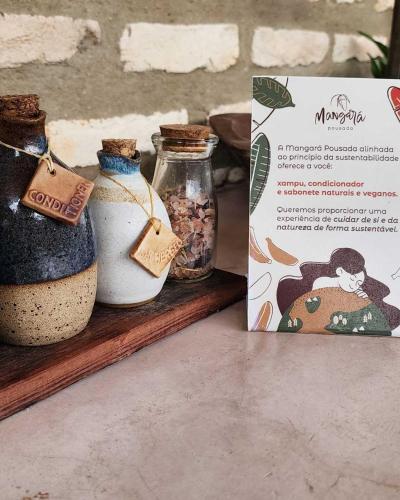 a box and two jars of food on a shelf at Mangará Pousada in Praia de Moitas