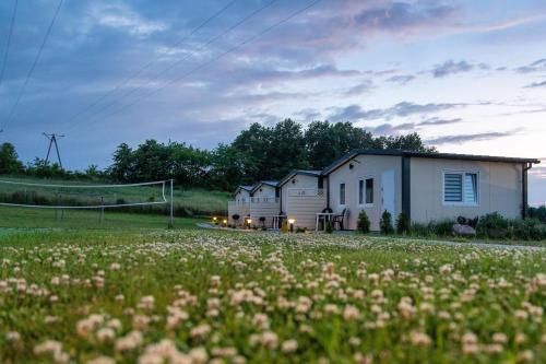 a house in a field with a soccer goal at Perłowe Wzgórze in Ustronie Morskie