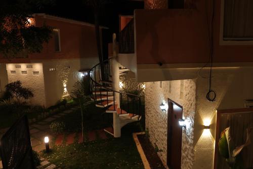 a staircase in a house at night with lights at PALM PARADISE Beach Resort in Puducherry