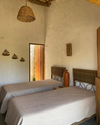 a bedroom with two beds and a window at Casa Monã in Maceio