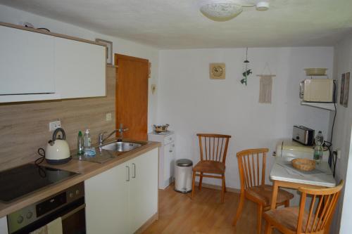 a kitchen with a sink and a table with chairs at Ferienhaus Familie Sommer in Monschau