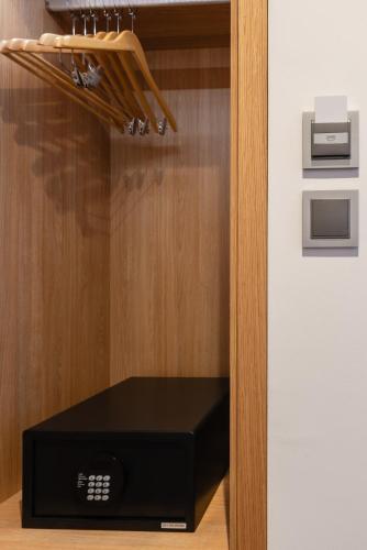 a black speaker in a cabinet with a drawer at Brit Hotel Privilège Paris Rosny-sous-Bois in Rosny-sous-Bois