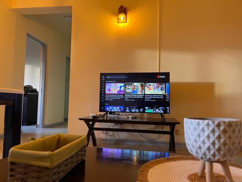 a living room with a flat screen tv on a table at Sunset view in Ebene