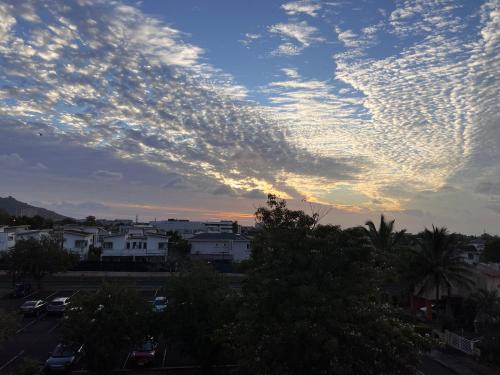 a cloudy sky over a city at sunset at Sunset view in Ebene