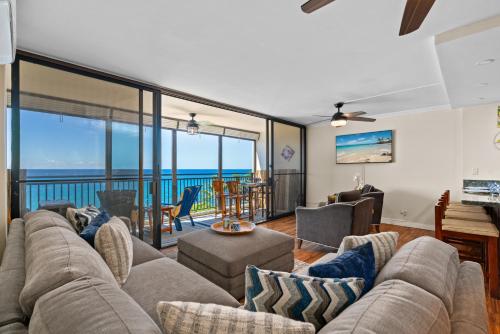 a living room with a couch and a view of the ocean at 402 Kona Alii in Kailua-Kona