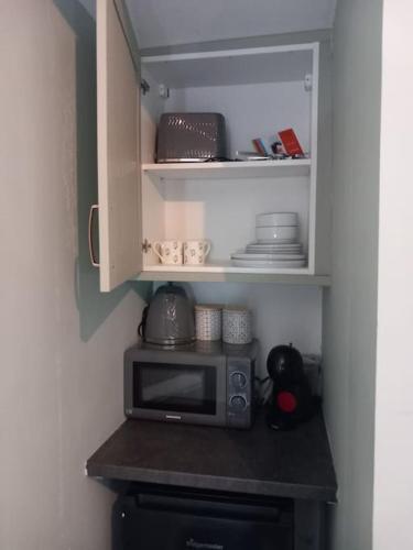 a microwave sitting on a counter in a kitchen at The Nook- Cotswold guest room in Mickleton