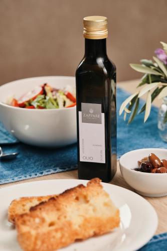 a bottle of wine sitting next to a plate of food at Agriturismo Zapparè Farm Hotel in Trevignano