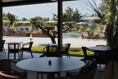 a patio with tables and chairs and a pool at Agriturismo Zapparè Farm Hotel in Trevignano