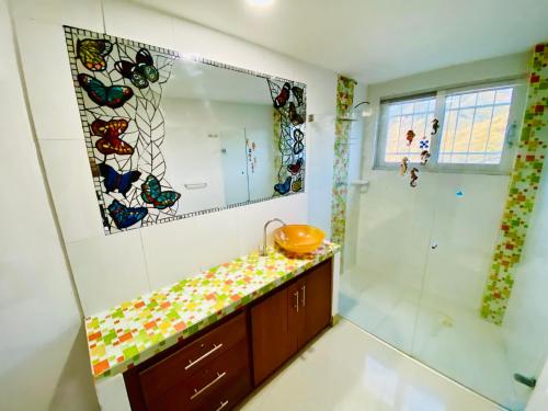 a bathroom with a shower and a sink and a mirror at Sol y Luna apartment in Santa Marta