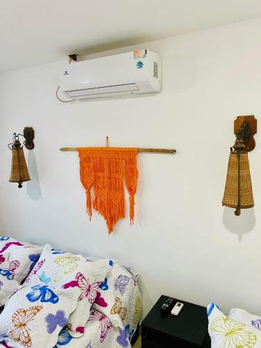 a room with a bed and a air conditioner on a wall at Sol y Luna apartment in Santa Marta
