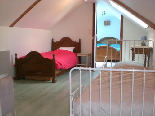 a bedroom with a bed and a mirror at La Roseraie, campagne, calme et paix in Bulson