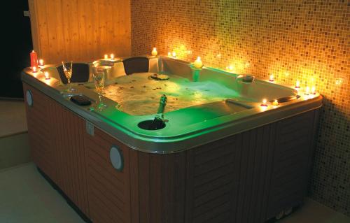 a bathroom with a tub with lights in it at Vila Pina in Zlatibor
