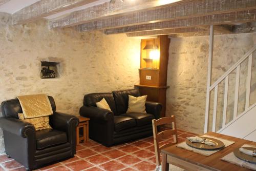 a living room with two chairs and a table at Willow Cottage at Petite Ferme Embir in La Châtre