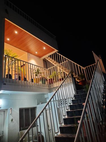 a set of stairs in a building at night at Shriguru Guest House Akkalkot in Akalkot