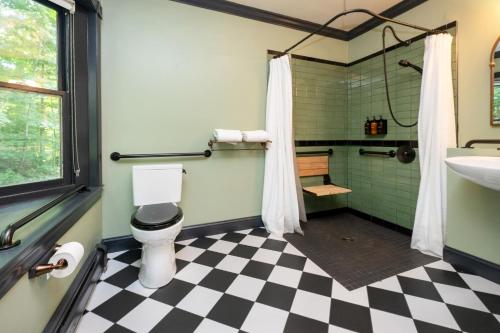 a bathroom with a black and white checkered floor at The Constance by The Lenox Collection in Lenox