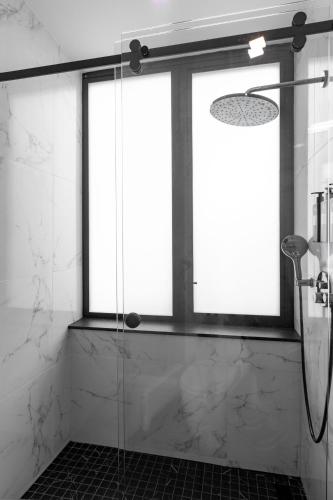 a bathroom with a shower with a glass door at Broadway Plaza Hotel in New York