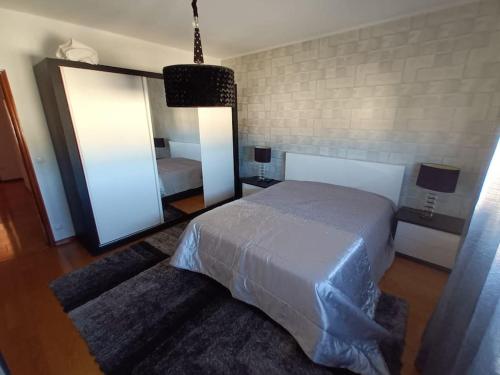 a bedroom with a bed and a large mirror at Casa Fatinha in Amarante